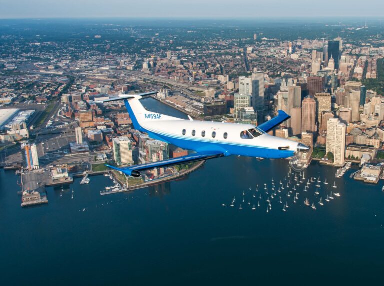 PlaneSense aircraft including Pilatus PC 24 jet and Pilatus PC 12 flying over Boston Harbor