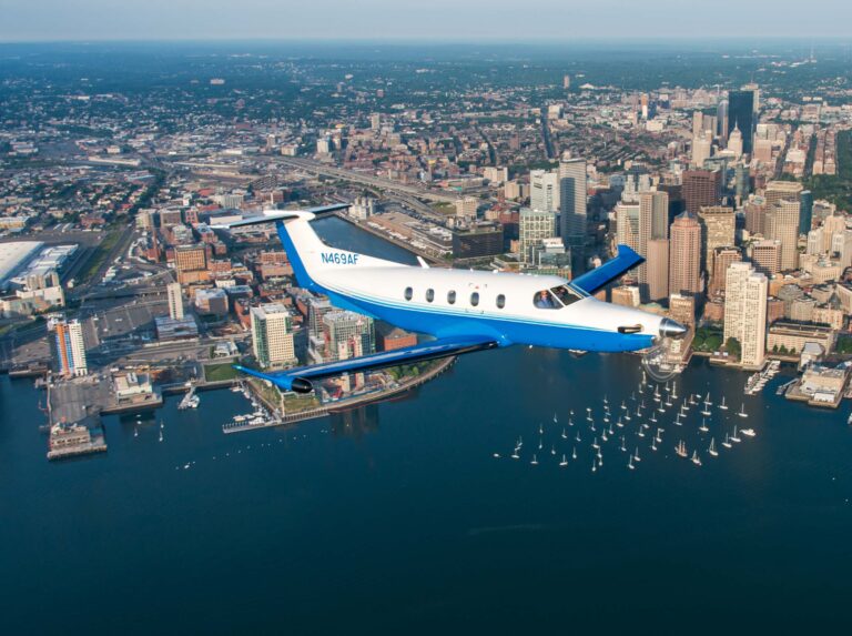 PlaneSense aircraft including Pilatus PC 24 jet and Pilatus PC 12 flying over Boston Harbor