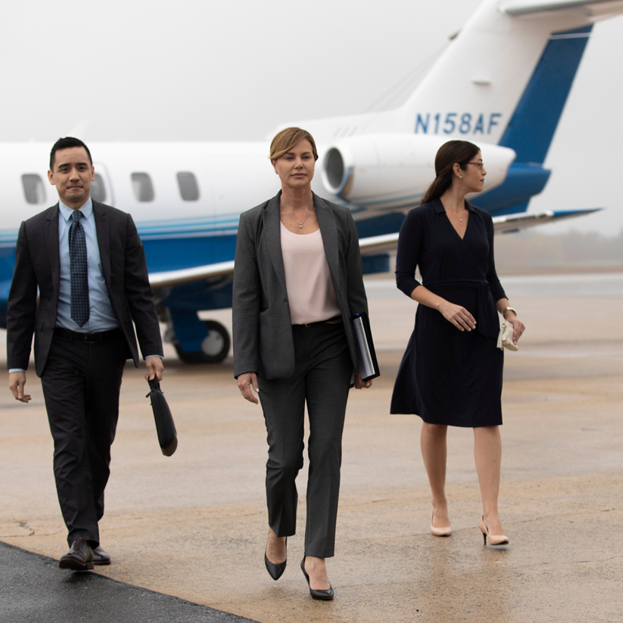 business team walking off of Pilatus PC-24 business jet