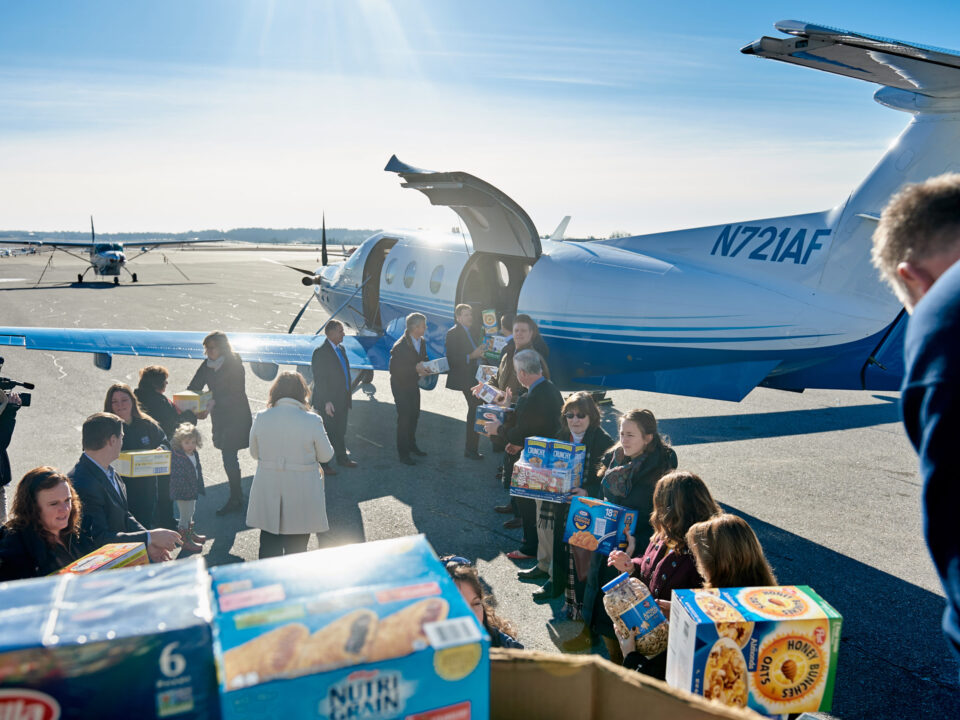 Loading a PlaneSense PC-12 with donations for NH Food Bank