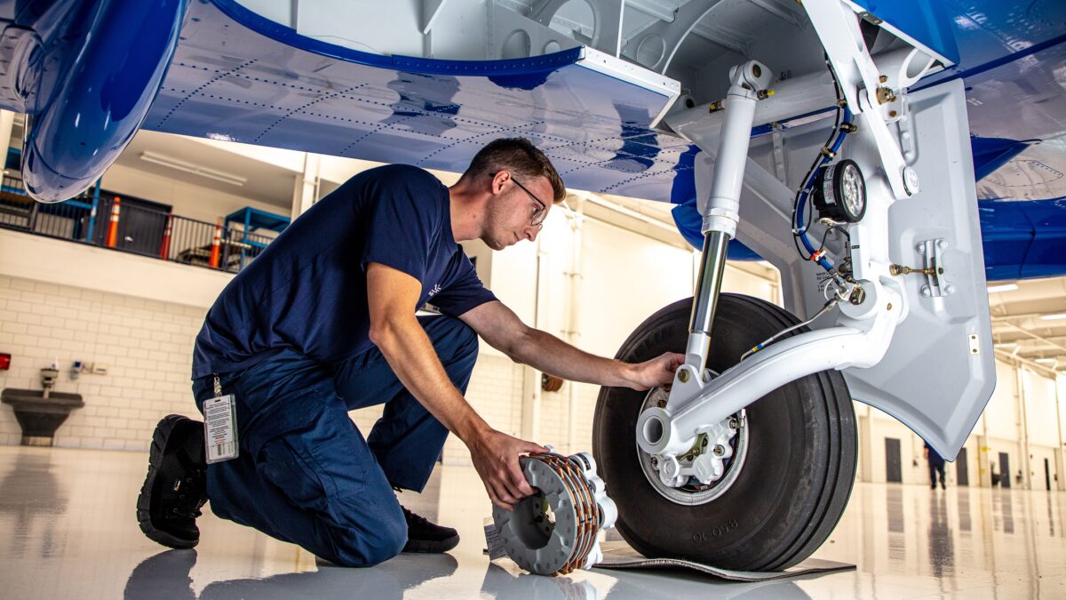 Atlas Aircraft Center Mechanic Repairing Plane
