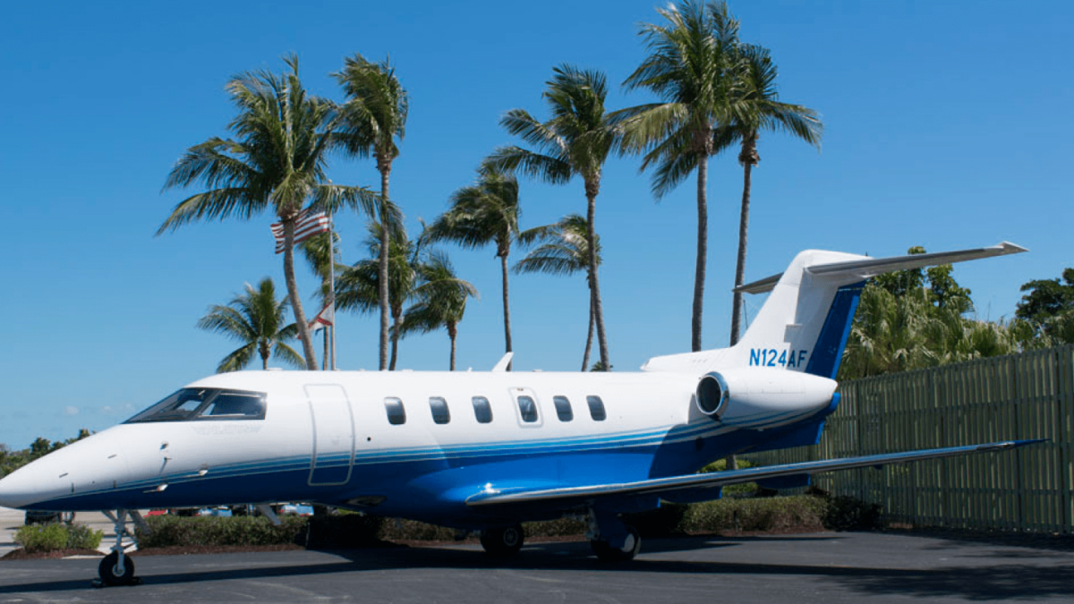 fractional jet program aircraft on the tarmac with palm trees