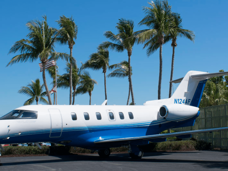 fractional jet program aircraft on the tarmac with palm trees